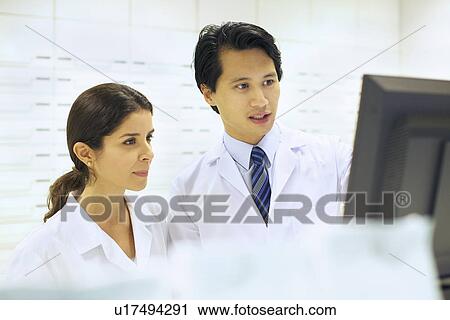 Pharmacists working on computer in pharmacy View Large Photo Image Stock Image - Pharmacists working on computer in pharmacy. Fotosearch