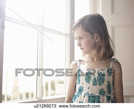 Portrait of a girl looking out of bedroom window View Large Photo Image Stock Image - Portrait of a girl looking out of bedroom window. Fotosearch