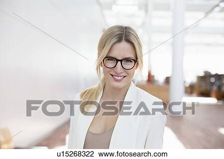 Stock Image - Portrait of business woman at airport. Fotosearch