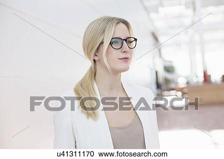 Stock Image - Portrait of business woman at airport. Fotosearch