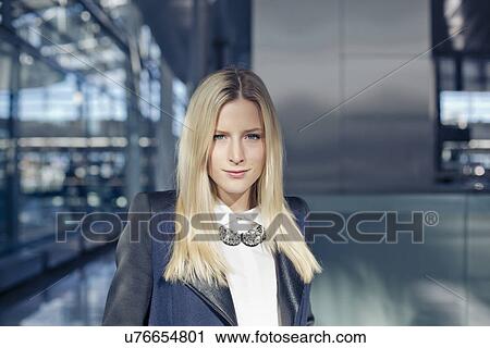 Stock Image - Portrait of business woman at airport. Fotosearch