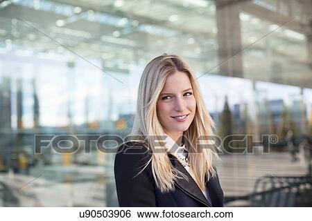 Stock Photograph - Portrait of business woman at airport. Fotosearch