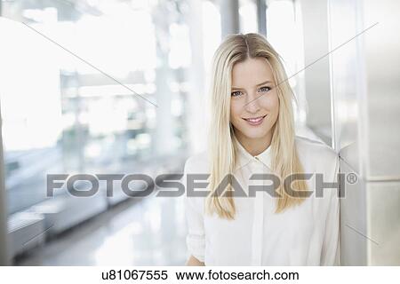 Stock Photography - Portrait of business woman at airport. Fotosearch