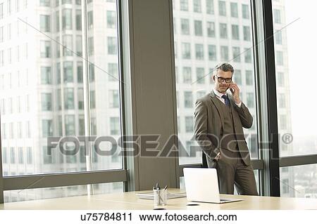 Stock Image - Portrait of businessman in high rise office. Fotosearch