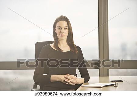 Portrait of businesswoman at office desk View Large Photo Image Picture - Portrait of businesswoman at office desk. Fotosearch