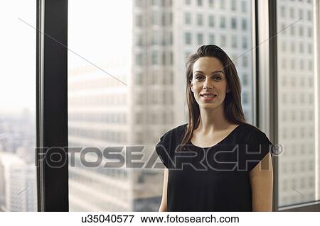 Stock Photo - Portrait of businesswoman in high rise office. Fotosearch