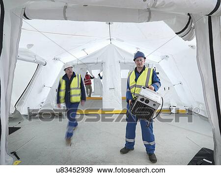 Stock Photo - Portrait of Emergency Response Team worker in control centre tent. Fotosearch