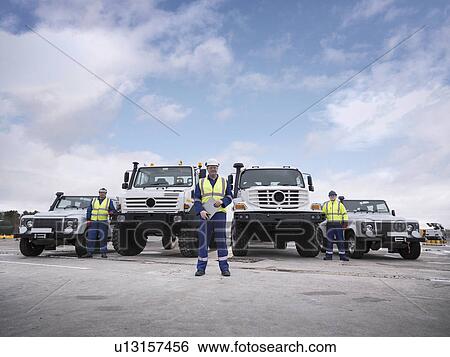 Portrait of Emergency Response Team workers with specialist trucks View Large Photo Image Stock Photograph - Portrait of Emergency Response Team workers with specialist trucks. Fotosearch