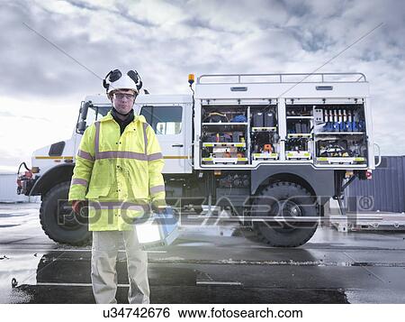 Portrait of Emergency Response worker with specialist equipment and rescue truck View Large Photo Image Stock Photograph - Portrait of Emergency Response worker with specialist equipment and rescue truck. Fotosearch
