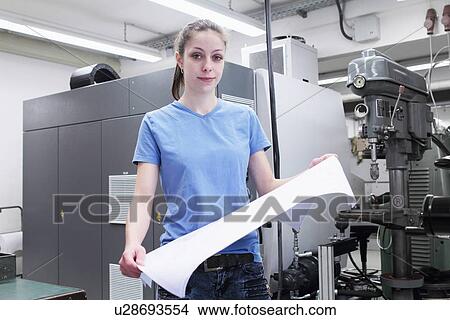Portrait of female engineer holding blueprint View Large Photo Image Picture - Portrait of female engineer holding blueprint. Fotosearch