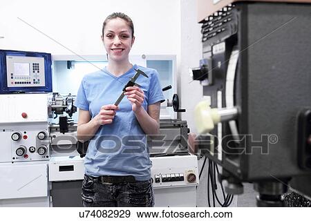 Portrait of female engineer holding tool View Large Photo Image Stock Photo - Portrait of female engineer holding tool. Fotosearch