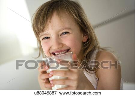 Portrait of girl drinking a glass of milk View Large Photo Image Stock Photo - Portrait of girl drinking a glass of milk. Fotosearch