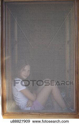 Portrait of girl sitting in obscured window frame View Large Photo Image Stock Photo - Portrait of girl sitting in obscured window frame. Fotosearch