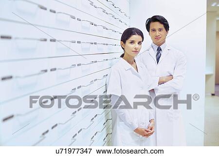 Stock Photo - Portrait of male and female pharmacists in pharmacy. Fotosearch