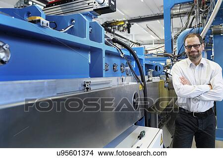 Portrait of manager and machinery in workshop View Large Photo Image Picture - Portrait of manager and machinery in workshop. Fotosearch
