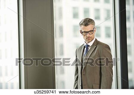 Portrait of mature businessman in high rise office View Large Photo Image Stock Image - Portrait of mature businessman in high rise office. Fotosearch