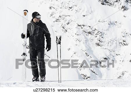 Portrait of mid adult man holding skies, Obergurgl, Austria View Large Photo Image Stock Photography - Portrait of mid adult man holding skies, Obergurgl, Austria. Fotosearch
