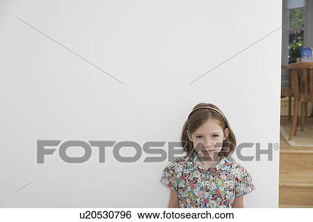 Portrait of shy young girl next to white wall View Large Photo Image Stock Photograph - Portrait of shy young girl next to white wall. Fotosearch