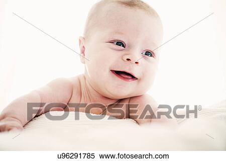 Portrait of smiling baby boy lying on front View Large Photo Image Stock Photography - Portrait of smiling baby boy lying on front. Fotosearch