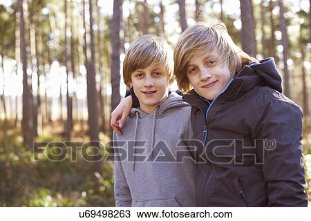Portrait of twin brothers in forest View Large Photo Image Stock Image - Portrait of twin brothers in forest. Fotosearch