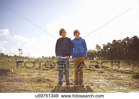 Stock Photo - Portrait of twin brothers in forest clearing. Fotosearch