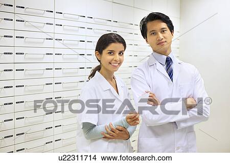 Portrait of two pharmacists in pharmacy View Large Photo Image Picture - Portrait of two pharmacists in pharmacy. Fotosearch