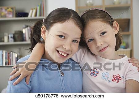Portrait of two sisters in a kitchen View Large Photo Image Stock Photograph - Portrait of two sisters in a kitchen. Fotosearch