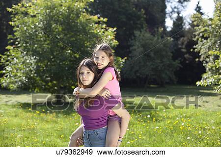 Portrait of two sisters in the park View Large Photo Image Stock Photo - Portrait of two sisters in the park. Fotosearch