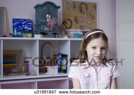 Portrait of young girl in her bedroom View Large Photo Image Stock Photo - Portrait of young girl in her bedroom. Fotosearch