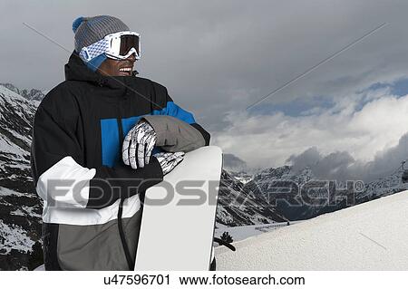 Stock Image - Portrait of young male snowboarder, Obergurgl, Austria. Fotosearch