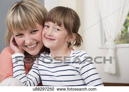 Stock Image - Portrait of young woman and girl. Fotosearch