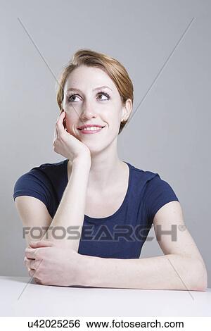 Portrait of young woman, chin on hand View Large Photo Image Stock Photograph - Portrait of young woman, chin on hand. Fotosearch