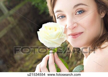 Picture - Portrait of young woman holding a rose. Fotosearch