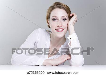 Portrait of young woman, resting on hand View Large Photo Image Stock Photo - Portrait of young woman, resting on hand. Fotosearch