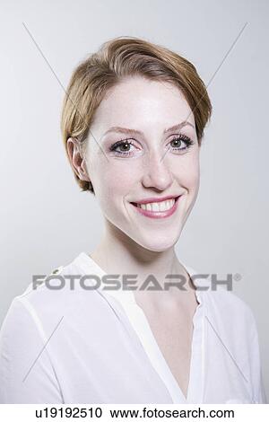 Portrait of young woman, smiling View Large Photo Image Stock Image - Portrait of young woman, smiling. Fotosearch