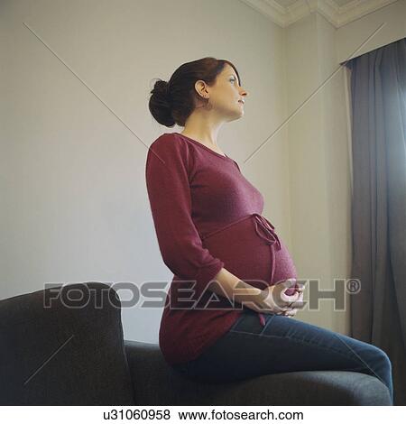 Pregnant woman looking away View Large Photo Image Stock Photo - Pregnant woman looking away. Fotosearch