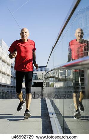 Runner alongside glass balustrade, Munich, Germany View Large Photo Image Stock Photo - Runner alongside glass balustrade, Munich, Germany. Fotosearch
