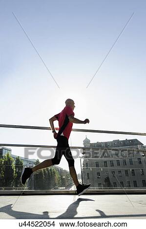 Runner crossing bridge, Munich, Germany View Large Photo Image Picture - Runner crossing bridge, Munich, Germany. Fotosearch