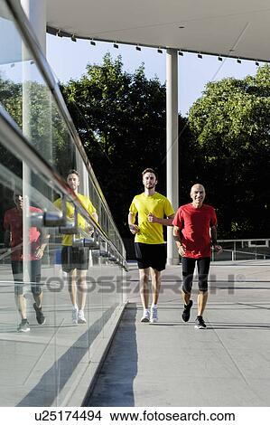 Runners alongside glass balustrade View Large Photo Image Picture - Runners alongside glass balustrade. Fotosearch