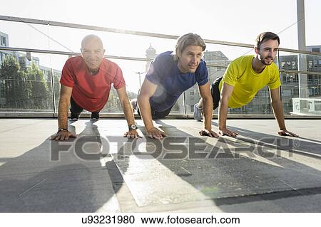 Runners doing push ups, Munich, Germany View Large Photo Image Stock Image - Runners doing push ups, Munich, Germany. Fotosearch