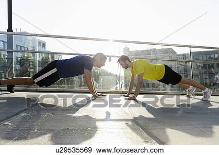 Stock Photo - Runners doing push ups, Munich, Germany. Fotosearch