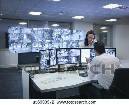 Security Guards Working At Cctv Screens In Control Room Stock Image