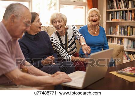 Senior man and female companions in retirement villa View Large Photo Image Stock Image - Senior man and female companions in retirement villa. Fotosearch