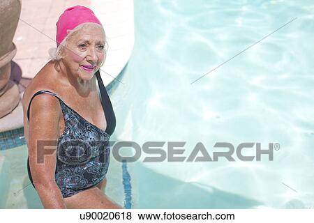 Senior woman enjoying swimming pool at retirement villa View Large Photo Image Stock Photo - Senior woman enjoying swimming pool at retirement villa. Fotosearch