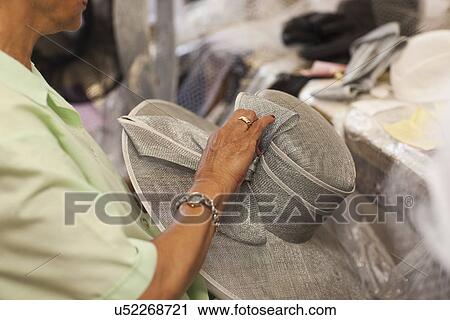 Senior woman holding hat in traditional milliners shop View Large Photo Image Stock Image - Senior woman holding hat in traditional milliners shop. Fotosearch
