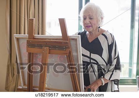 Senior women painting art canvas in retirement villa View Large Photo Image Stock Photo - Senior women painting art canvas in retirement villa. Fotosearch