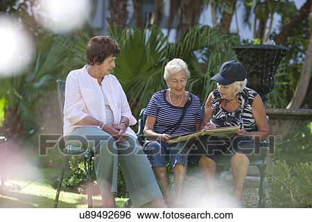 Senior women relaxing in retirement villa garden View Large Photo Image Stock Photograph - Senior women relaxing in retirement villa garden. Fotosearch