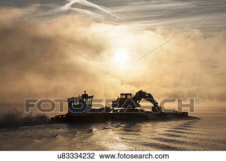 Silhouette of excavator on barge, Lake Maggiore, Stresa, Piemonte, Italy View Large Photo Image Stock Image - Silhouette of excavator on barge, Lake Maggiore, Stresa, Piemonte, Italy. Fotosearch