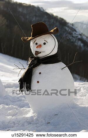 Snowman on mountainside wearing hat and scarf View Large Photo Image Stock Photography - Snowman on mountainside wearing hat and scarf. Fotosearch
