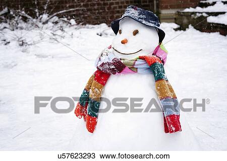 Stock Image - Snowman wearing hat and scarf. Fotosearch